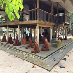  Monks meditating under Ajahn Chah's kuti while listening to a dhamma talk.